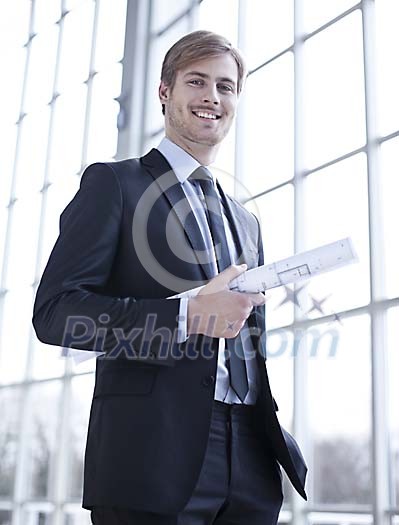 Businessman standing with a blueprint