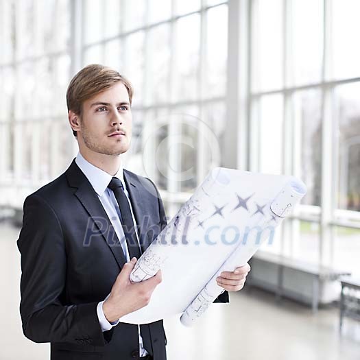 Businessman with a blueprint Businessman with a blueprint