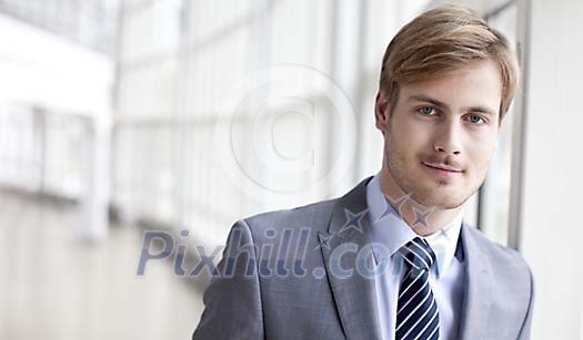 Young businessman by the window