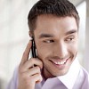 Businessman smiling and talking to a phone