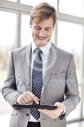 Businessman standing with a tablet computer