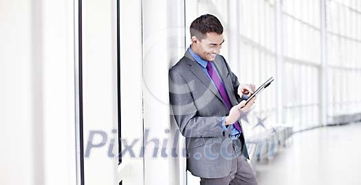Businessman looking at his tablet computer