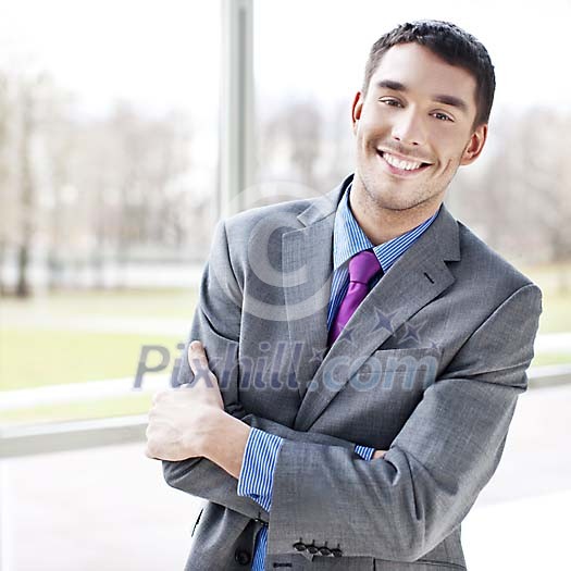 Smiling businessman by the window