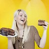 Smiling woman with a chocolate cake