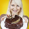 Woman offiring a chocolate cake on a plate