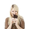 Woman taking a bite of the chocolate bar
