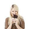 Woman taking a bite of the chocolate bar