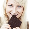 Woman taking a bite of chocolate