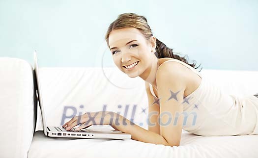 Woman on the sofa with a laptop
