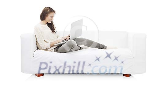 Isolated woman on the couch with a laptop