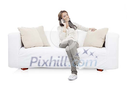 Isolated woman talking to a phone on the sofa