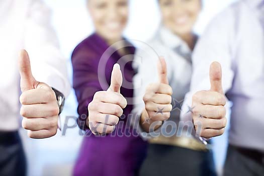 Business people giving thumbs up Business people giving thumbs up