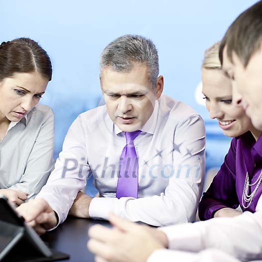 Group of business people behind a table