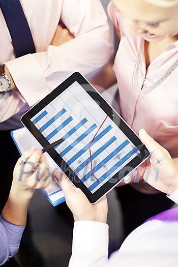 People looking at the chart on the tablet computer People looking at the chart on the tablet computer