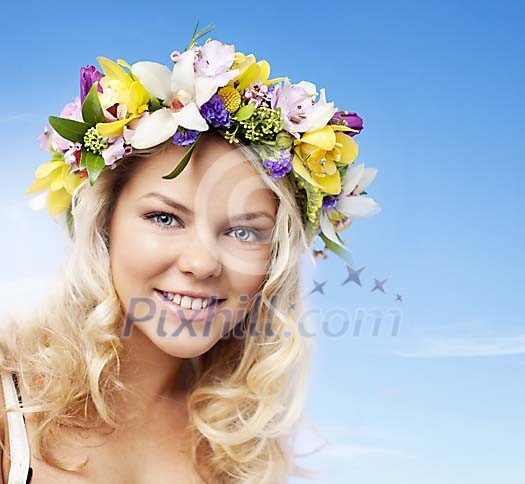Face portrait of a beautiful blonde girl wearing a floral head wreath
