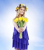 Natural Nordic summer girl handing out a flower bouquet