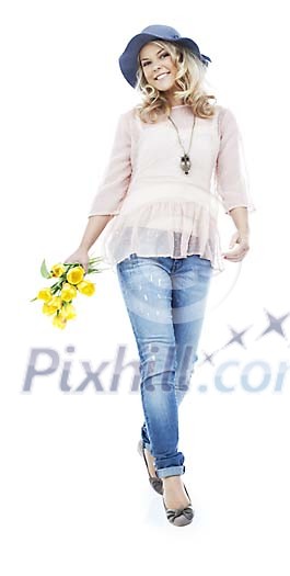 young blonde woman walking towards camera holding a yellow flower bouquet