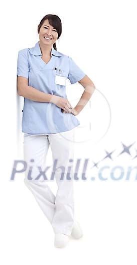 Isolated female nurse leaning against the wall Isolated female nurse leaning against the wall