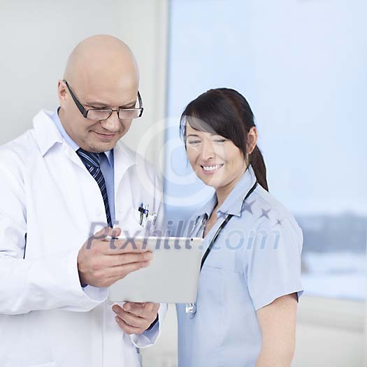 Doctor and a nurse with a tablet computer