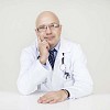 Male doctor sitting by the desk, listening