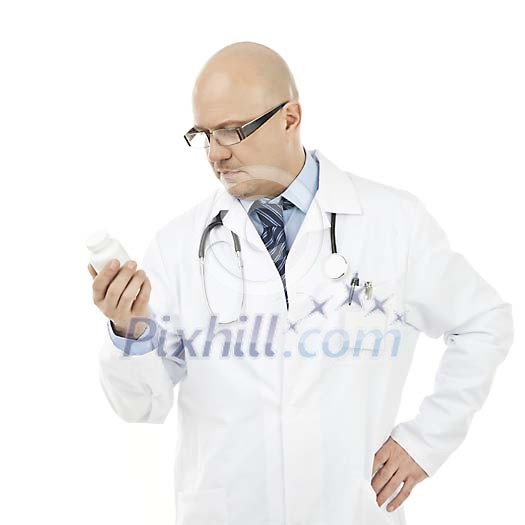 Male doctor looking at the medicine jar Male doctor looking at the medicine jar