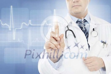 Male doctor monitoring an EKG on a touchscreen Male doctor monitoring an EKG on a touchscreen