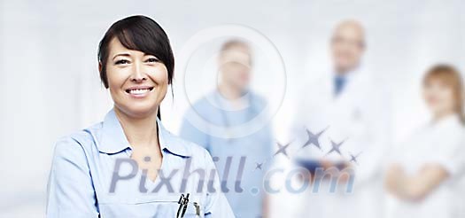 Smiling nurse with other staff Smiling nurse with other staff