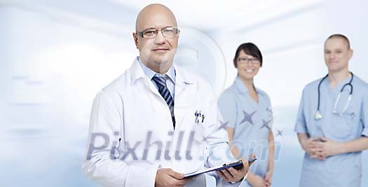 Male doctor with two nurses Male doctor with two nurses