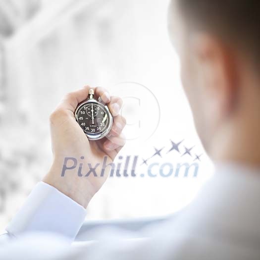 Man holding a stopwatch Man holding a stopwatch