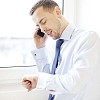 Businessman talking to a phone by the window