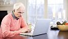 Senior man by laptop at home