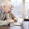 Senior couple using a laptop at home