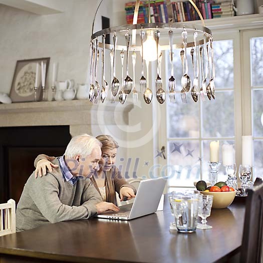 Senior couple using a laptop computer at home Senior couple using a laptop computer at home