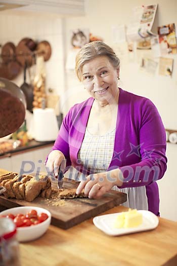 Senior woman preparing breakfast in the kitchen