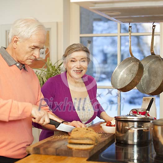 Senior couple cooking together in the kitchen