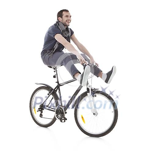 Isolated man doing a trick on the bicycle