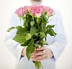 Male hands holding a bouquet of pink roses