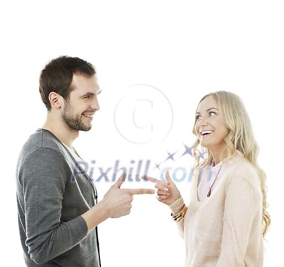 Isolated man and woman pointing fingers at eachother