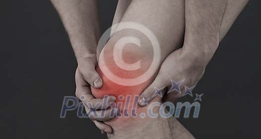 Man holding his sore knee