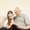 Grandpa reading with his granddaughter