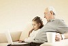 Girl with her grandpa sitting on the sofa