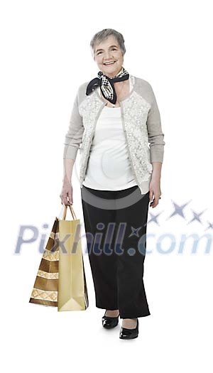 Isolated older lady with shopping bags