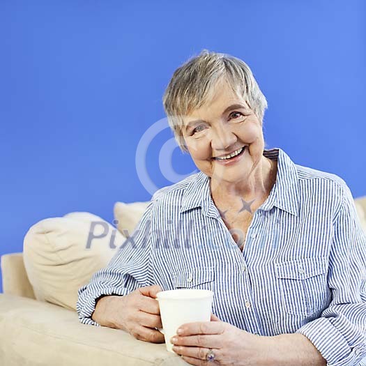 Older woman with a coffee-cup Older woman with a coffee-cup