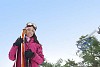 Woman standing with skis outside