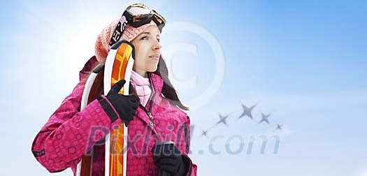 Woman standing with skis