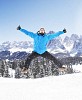 Happy man jumping in the snow