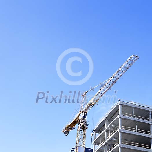 Crane and a house being built Crane and a house being built