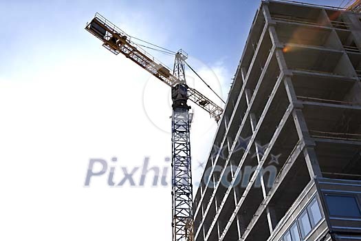 Crane and a house being built Crane and a house being built