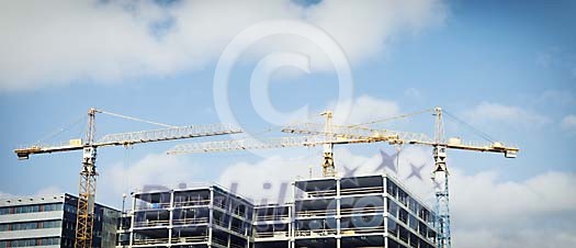 Houses being built with cranes