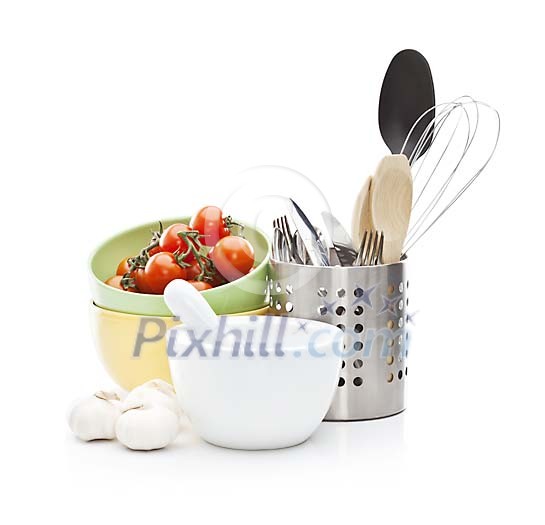 Isolated kitchen utensils with vegetables